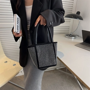 Chic black rhinestone bucket bag with sparkling studs and elegant top handle for women