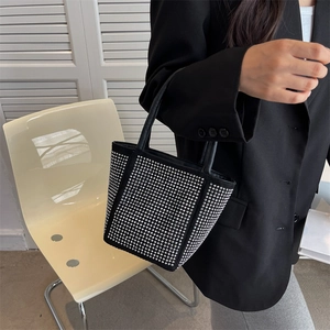 Fashionable black rhinestone bucket bag with silver studs and elegant top handles