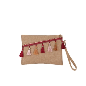 Ethnic woven envelope clutch bag with colorful tassels and wrist strap on white background