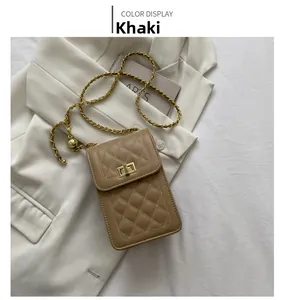 Detail of khaki quilted crossbody bag with golden chain strap and metallic twist lock