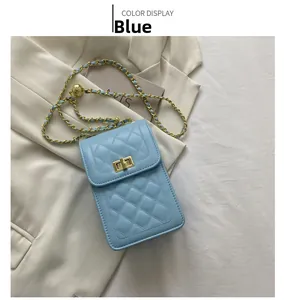 Blue quilted mini crossbody bag featuring a golden chain strap and twist-lock closure