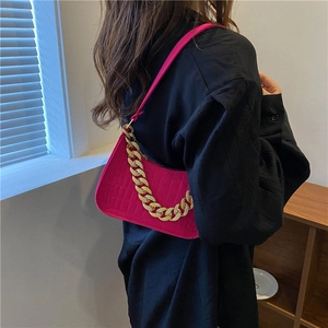 Magenta crocodile embossed handbag with thick gold chain and leather shoulder strap