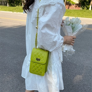 Chic lime green quilted shoulder bag with gold chain strap and metal lock closure