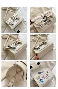 Détails du sac bandoulière blanc avec graffitis colorés et texture en cuir litchi