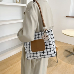 Classic checkered tote bag with brown leather pocket and cute tiger pendant on a shoulder strap