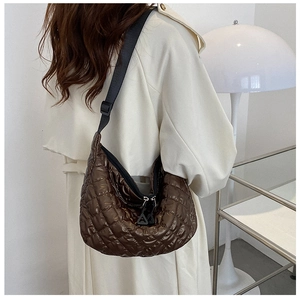 Detail of dark brown quilted hobo bag with adjustable wide shoulder strap in nylon