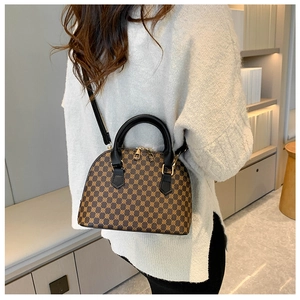 Detailed back view of a mini brown monogram shell bag styled with a beige sweater