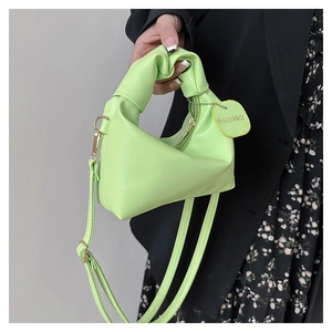 Lime green mini handbag featuring a unique knotted handle and smooth PU leather texture
