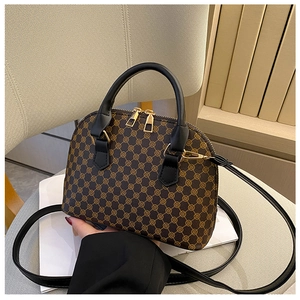 Detail of vintage bowling bag with classic monogram pattern and gold-tone hardware