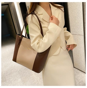 Detail view of contrast color stitching and adjustable strap on large tote bag