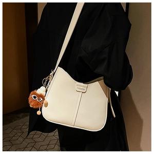 White leather bucket bag with fashion lettering and brown plush toy charm detail