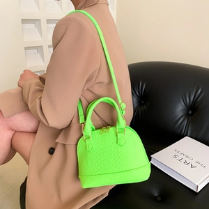 Neon green shell-shaped handbag with lizard texture and gold zippers for women