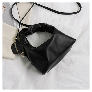 Detail of black PU leather bag showing triangle structure and ruched handle design