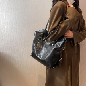 Classic black PU leather tote bag for women with gold buckles and a minimalist design