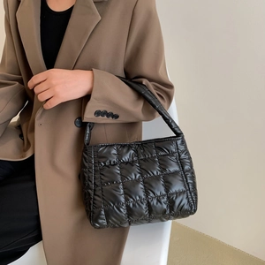 Chic black quilted puffy shoulder bag with a padded handle for women in a casual style