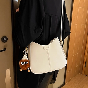 Minimalist off-white Hobo shoulder bag with fashion label and cute plush charm pendant