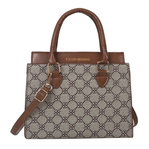 Minimalist brown floral canvas tote bag with leather handles and gold fashion lettering