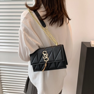 Retro black quilted leather crossbody bag with gold chain strap and metallic tassel