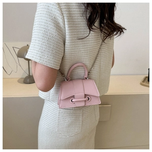 Pink mini crossbody bag featuring metal eyelet buckle detail and silver chain strap