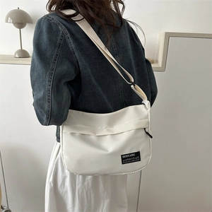 Minimalist white nylon tote bag with adjustable shoulder strap for casual daily use