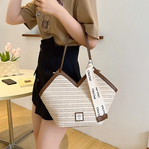 Large V-shaped straw tote bag with brown leather trim and stylish woven texture