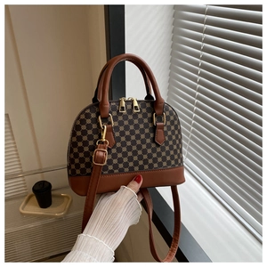 Detail of vintage shell bag showing classic monogram pattern and premium leather trim