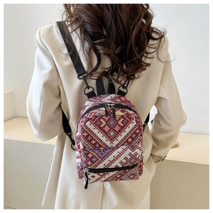 Ethnic bohemian mini backpack with geometric pattern shown on model in white blazer
