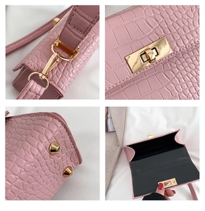 Detail view of pink croc-embossed handbag featuring gold-tone hardware and secure clasp