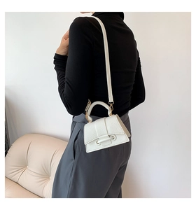 Mini white hourglass handbag with lychee texture leather worn crossbody by model