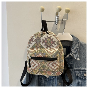 Detailed close-up of ethnic jacquard woven mini backpack with geometric diamond pattern