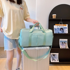Mint green waterproof travel duffel bag for fitness and short trips on luggage handle