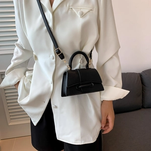 Chic black litchi pattern leather mini bag with curved bottom and crossbody strap