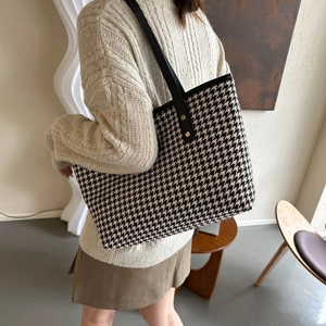 Chic houndstooth tote bag with black leather handles and gold rivet accents for women