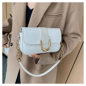 Detailed view of white crocodile pattern shoulder bag with a large golden horsebit buckle