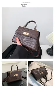 Detail of coffee brown crossbody bag featuring crocodile pattern leather and gold lock