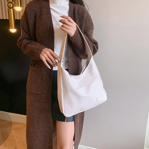 Minimalist beige large capacity tote bag in smooth leather for a stylish casual look