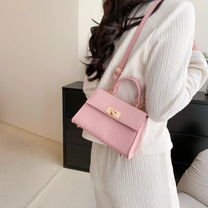 Pink faux crocodile leather crossbody bag with gold metallic lock and adjustable strap