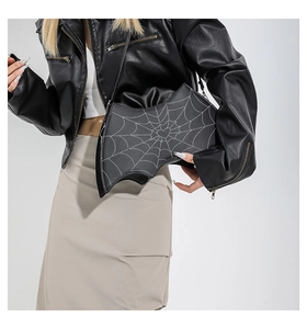 Detail of Gothic bat wing handbag with white spider web stitching and leather texture