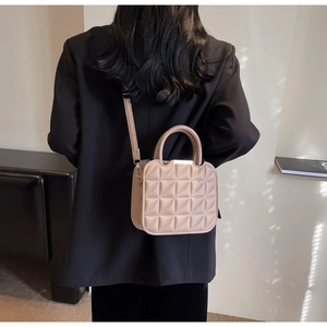 Quilted triangular pattern texture detail on chic beige crossbody bag for women