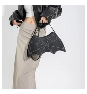 Detail of black gothic spider web handbag featuring white contrast stitching and unique bat shape