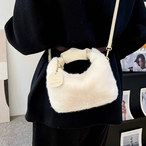 White plush faux fur crossbody handbag with twisted leather handle and gold chain detail