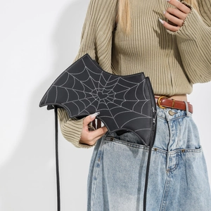 Gothic bat-shaped crossbody bag with white spiderweb stitching and bronze metal hardware