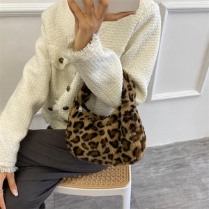 Stylish leopard print faux fur handbag with zipper closure shown on a female model