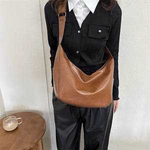 Retro brown large capacity PU leather shoulder bag for women shown in a minimalist room