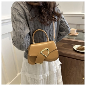 Detailed view of the ginger yellow PU leather handbag with a golden D-shaped buckle