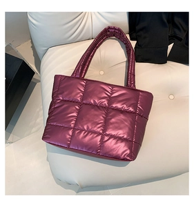 Detailed close-up of metallic purple quilted tote bag with smooth puffer texture