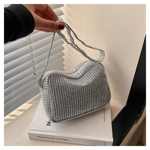 Macro detail of silver rhinestone hobo bag showing sparkling wave edges and shoulder strap