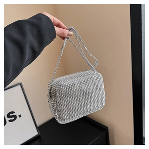 Close-up of sparkling silver rhinestone square bag with matching crystal strap detail