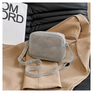 Detailed macro view of shimmering silver rhinestones and zipper on a luxury square bag