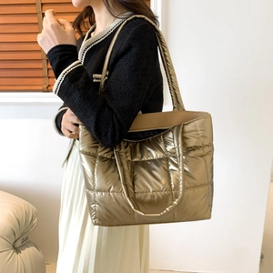 Metallic quilted tote bag with champagne gold finish, perfect for daily commuting usage